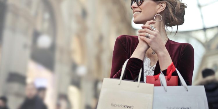Stylish woman with shopping bags in Galleria Vittorio Emanuele II, Milan.