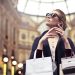 Elegant woman wearing sunglasses shopping in Milan's iconic Galleria Vittorio Emanuele II.